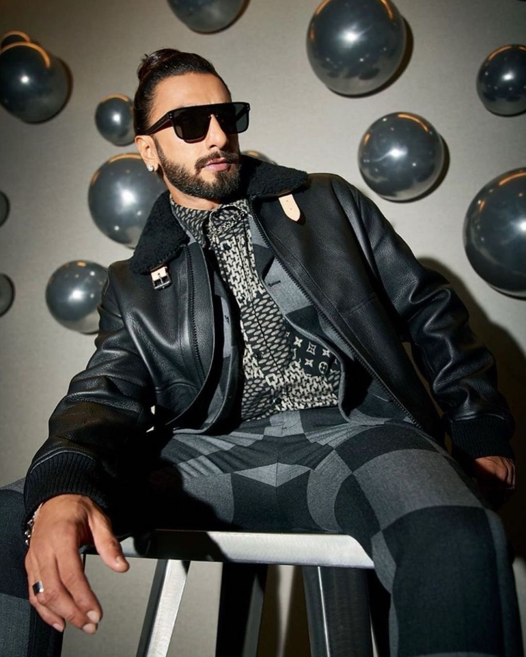 Ranveer Singh wears a black leather jacket and cool sunglasses