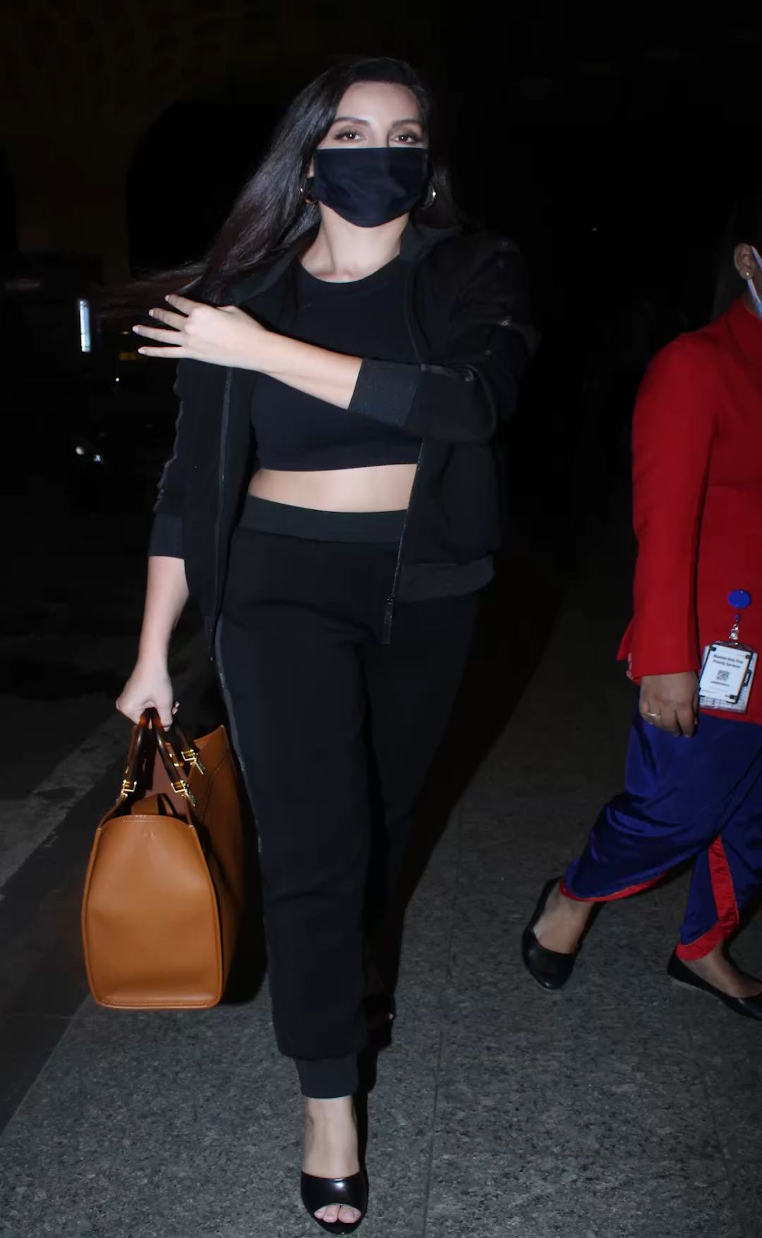 Nora Fatehi teams all-black top and leather pants with boots and