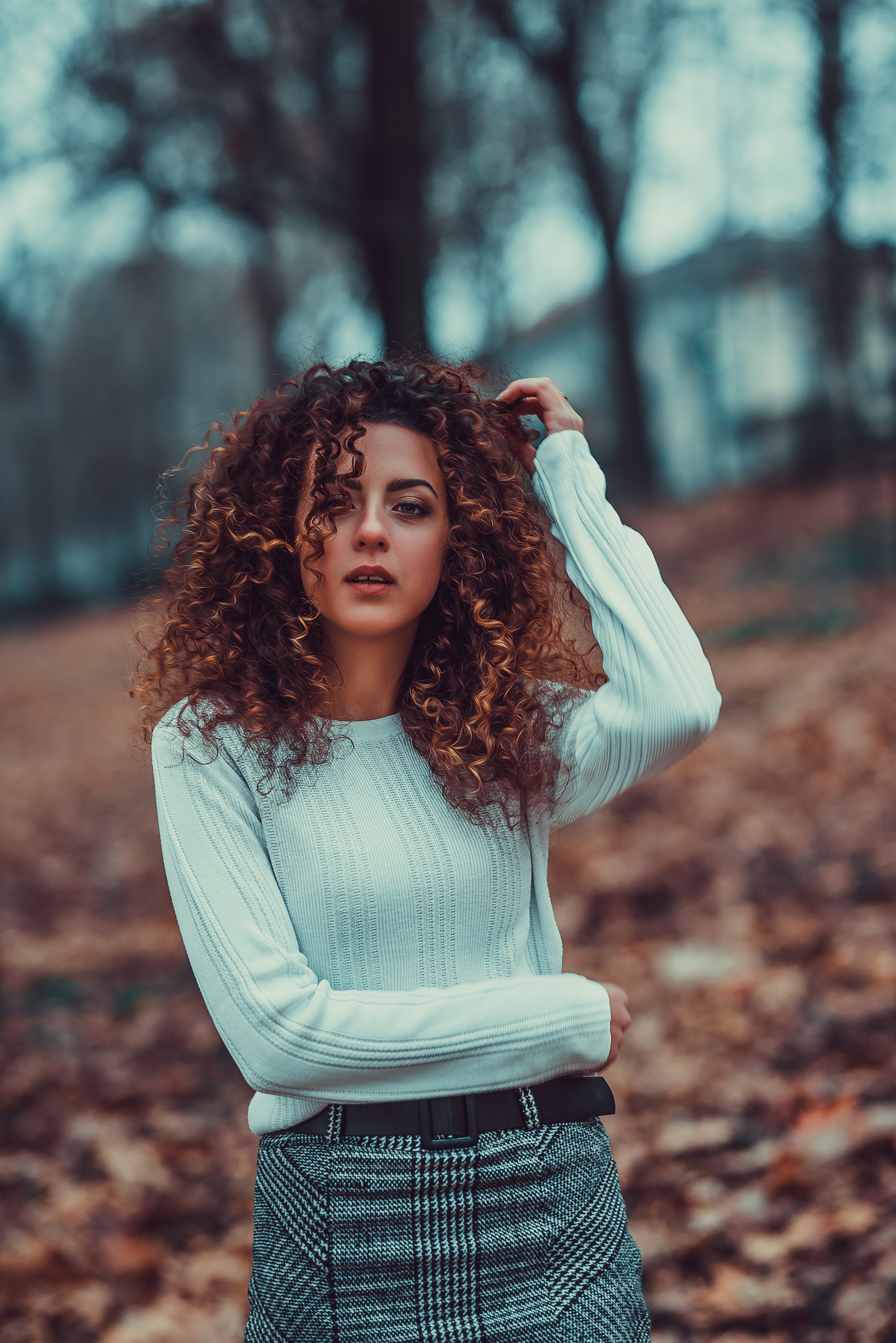 Nice girl with curly hair poses in the park Stock Photo | Adobe Stock