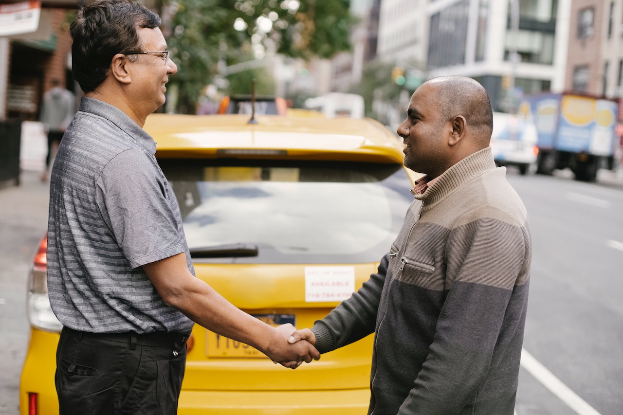 Men greeting each other on street