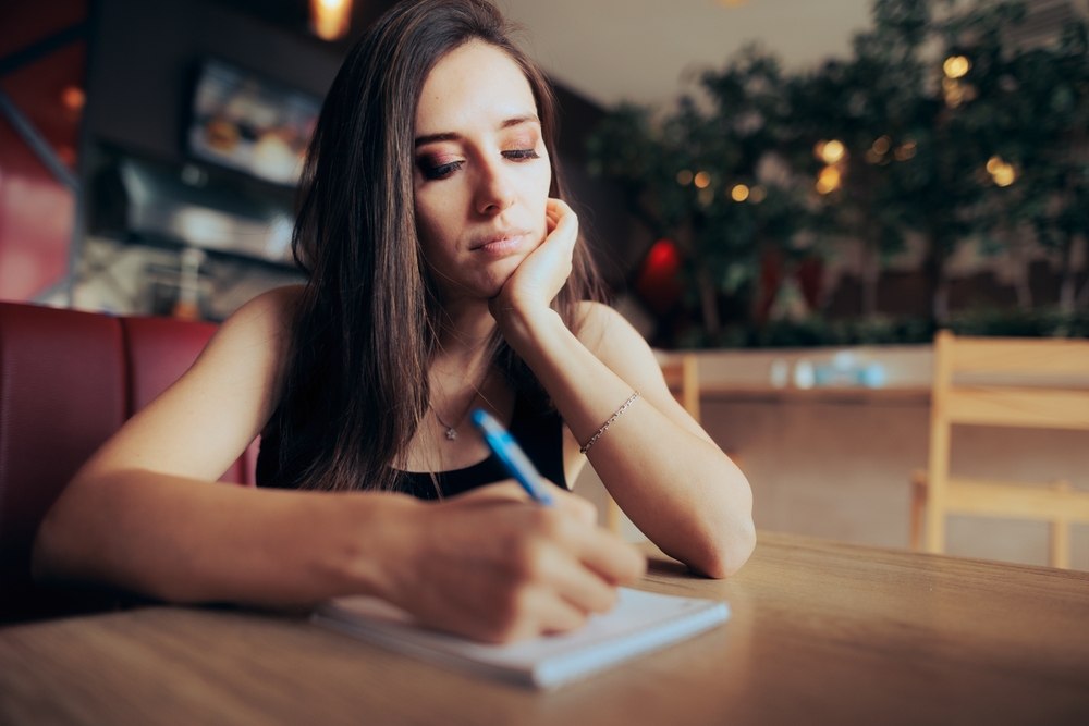 A wife writing down Apology Letters for Husband to clear misunderstanding