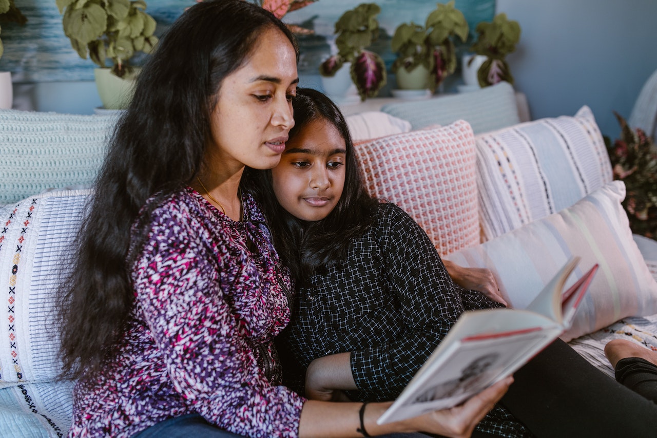 A mother reading poems to her daughter