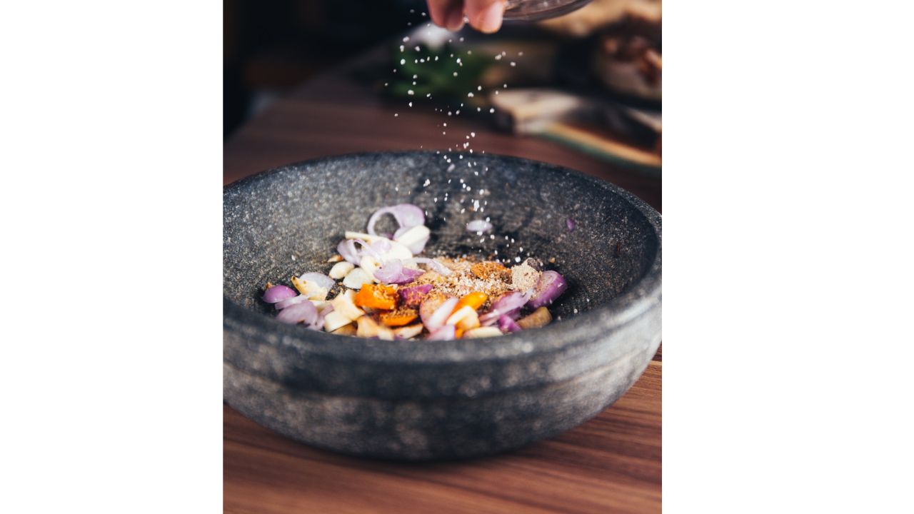 Person Pouring Salt in Bowl