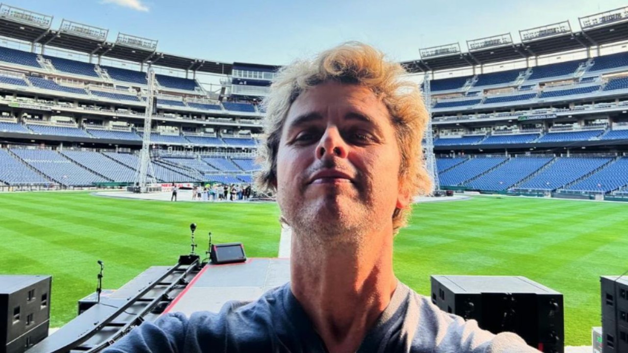 Billie Joe Armstrong spray paints over Oakland Athletics logo