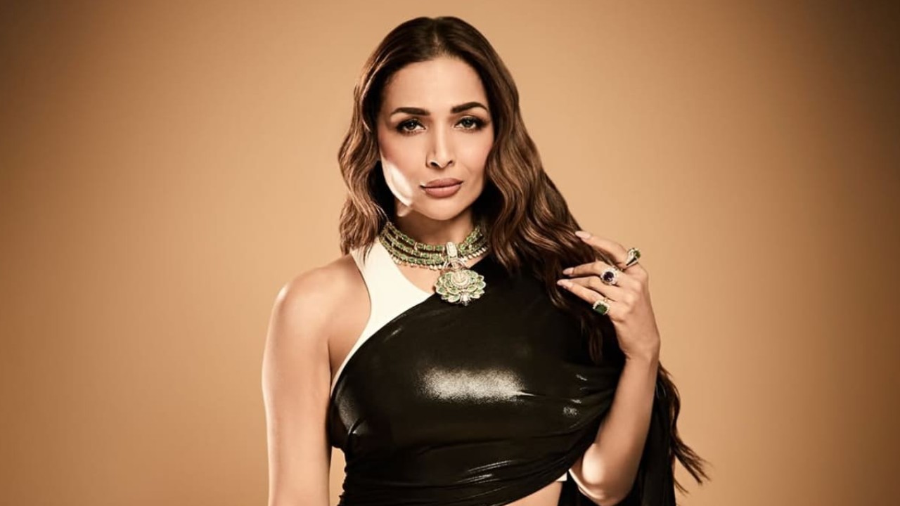 Malaika Arora's latest look screams BOLD in a black latex saree and white tank top