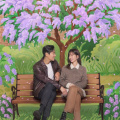 Love Your Enemy poster: Ju Ji Hoon and Jung Yu Mi gaze lovingly at each other under blooming lilacs; SEE