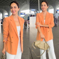 Kiara Advani flaunts her morning glow in off-duty airport look with orange blazer, white pants, and high-end Loewe bag