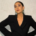 Karisma Kapoor looks bossy and bold in her tailored fit blazer jumpsuit styled perfectly with sleek hair bun