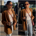 Alia Bhatt keeps her airport look trendy in oversized tan blazer with blue denim jeans and Rs 3,27,439 Gucci bag