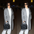 Katrina Kaif styles her classic white-on-white airport look with a trench coat and tinted Kala Chashma